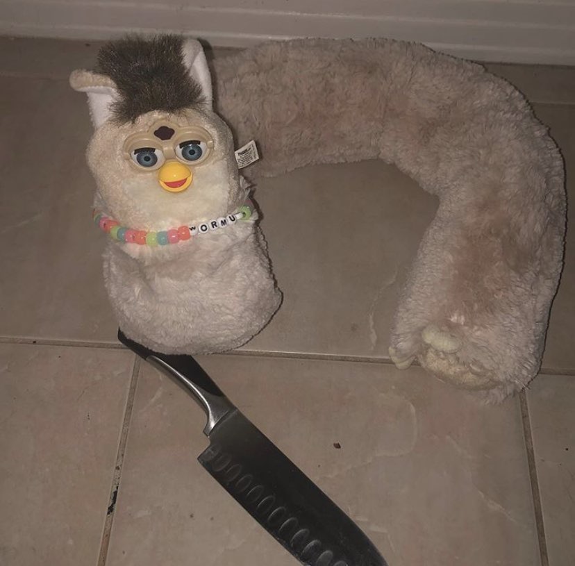Picture of a long furby with knife